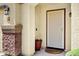 Welcoming front porch featuring brick accents, security door, and space for personalized decor at 23862 W Chambers St, Buckeye, AZ 85326