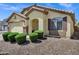 Well-maintained home with manicured bushes and decorative rock landscaping enhancing curb appeal at 23862 W Chambers St, Buckeye, AZ 85326