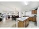 Open concept kitchen featuring a center island, dining area and view into the living room at 23862 W Chambers St, Buckeye, AZ 85326