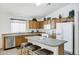Functional kitchen with stainless steel dishwasher and breakfast bar at 23862 W Chambers St, Buckeye, AZ 85326