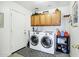 Laundry room equipped with modern appliances, storage cabinets and efficient layout at 23862 W Chambers St, Buckeye, AZ 85326