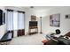 A well-lit home office features a work area, comfortable seating, and decor at 23862 W Chambers St, Buckeye, AZ 85326