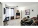 A functional home office has a large window, desk space, and a comfortable sitting area at 23862 W Chambers St, Buckeye, AZ 85326