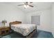 This bedroom offers a ceiling fan and a comfortable bed with a decorative floral comforter at 2400 E Baseline Ave # 71, Apache Junction, AZ 85119