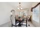 Inviting dining room with a modern chandelier, decorative mirror, and seating for six at 2400 E Baseline Ave # 71, Apache Junction, AZ 85119