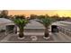 This home features palm trees, covered parking, desert landscaping, and an American flag at 2400 E Baseline Ave # 71, Apache Junction, AZ 85119