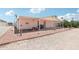Back of home with covered porch and low-maintenance landscaping at 2400 E Baseline Ave # 71, Apache Junction, AZ 85119