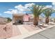 This single-story home features an American flag, mature palm trees, and a covered entryway at 2400 E Baseline Ave # 71, Apache Junction, AZ 85119