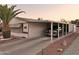 The home features covered parking, desert landscaping, and room for a truck at 2400 E Baseline Ave # 71, Apache Junction, AZ 85119