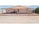 Exterior view of the home from the backyard featuring a covered patio at 2400 E Baseline Ave # 71, Apache Junction, AZ 85119