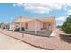View of the exterior with covered patio and gravel landscaping at 2400 E Baseline Ave # 71, Apache Junction, AZ 85119