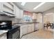 Bright kitchen featuring white cabinets, stainless steel appliances, and a sunny window at 2400 E Baseline Ave # 71, Apache Junction, AZ 85119