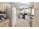 Well-equipped kitchen with white appliances, neutral countertops, and tile floors at 2400 E Baseline Ave # 71, Apache Junction, AZ 85119