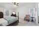 Spacious main bedroom featuring cozy seating and a ceiling fan at 2400 E Baseline Ave # 71, Apache Junction, AZ 85119