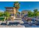 Inviting backyard featuring a unique custom playhouse, stylish patio furniture, and a lush palm tree at 2533 W Novak Way, Phoenix, AZ 85041