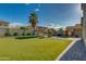 Expansive backyard featuring artificial turf, a custom playhouse, and paved patio with outdoor seating at 2533 W Novak Way, Phoenix, AZ 85041