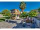 Beautiful backyard with a unique playhouse, a cozy seating area, and well-manicured potted trees at 2533 W Novak Way, Phoenix, AZ 85041
