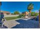 Spacious backyard with artificial turf, custom playhouse, and outdoor seating, all beautifully paved at 2533 W Novak Way, Phoenix, AZ 85041