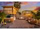 Backyard at dusk featuring a custom playhouse with string lights, and an outdoor seating area at 2533 W Novak Way, Phoenix, AZ 85041