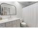 Bright bathroom featuring a white vanity, framed mirror, toilet, and white shower curtain at 2533 W Novak Way, Phoenix, AZ 85041