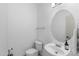Powder room with a pedestal sink, oval mirror, and a convenient towel bar at 2533 W Novak Way, Phoenix, AZ 85041