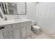 Well-lit bathroom with white marble vanity, brushed nickel faucet, framed mirror, and tile flooring at 2533 W Novak Way, Phoenix, AZ 85041