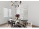 Dining room with modern table setting, stylish chairs, and natural lighting at 2533 W Novak Way, Phoenix, AZ 85041