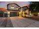 Inviting two-story home featuring desert landscaping, a spacious driveway, and a convenient two-car garage at 2533 W Novak Way, Phoenix, AZ 85041