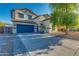 Charming two-story home with a well-maintained yard, a large driveway, and a blue two-car garage at 2533 W Novak Way, Phoenix, AZ 85041