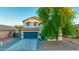 Two-story home with an attached two-car garage, manicured lawn, and desert landscaping at 2533 W Novak Way, Phoenix, AZ 85041