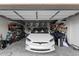 Spacious garage showcasing a white Tesla, bike rack, and storage shelves at 2533 W Novak Way, Phoenix, AZ 85041