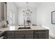 Open concept kitchen with stainless steel sink, quartz countertop and view to dining area at 2533 W Novak Way, Phoenix, AZ 85041