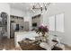 Modern kitchen and dining area with stylish light fixture and stainless steel appliances at 2533 W Novak Way, Phoenix, AZ 85041
