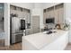 Well-lit kitchen features stainless steel appliances, spacious quartz counters, and ample cabinet space at 2533 W Novak Way, Phoenix, AZ 85041