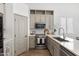 Kitchen features stainless steel appliances, grey cabinets, and modern finishes at 2533 W Novak Way, Phoenix, AZ 85041