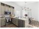 Kitchen with stainless steel appliances, grey cabinets, and an eat-in dining area at 2533 W Novak Way, Phoenix, AZ 85041
