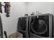 Modern laundry room with front loading washer and dryer, as well as tile floors at 2533 W Novak Way, Phoenix, AZ 85041