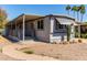Cozy gray home with a covered porch, desert landscaping and adjacent covered parking area at 2650 W Union Hills Dr # 29, Phoenix, AZ 85027