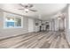 Open-concept living space with gray wood-look floors and a seamless flow into the updated kitchen at 2650 W Union Hills Dr # 29, Phoenix, AZ 85027