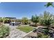 Spacious backyard with a patio, green lawn, and well-maintained landscaping, perfect for outdoor activities at 29403 N 119Th Ln, Peoria, AZ 85383