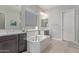 Modern bathroom with a soaking tub, dual vanities, and sleek fixtures for relaxation at 29403 N 119Th Ln, Peoria, AZ 85383