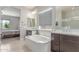 Spacious bathroom featuring a luxurious soaking tub, dual vanities, and ample natural light at 29403 N 119Th Ln, Peoria, AZ 85383