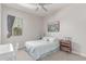 Cozy bedroom with neutral decor, featuring a bed with patterned bedding and a ceiling fan at 29403 N 119Th Ln, Peoria, AZ 85383