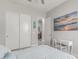 Cozy bedroom featuring ample closet space, a vanity desk, and soft natural light at 29403 N 119Th Ln, Peoria, AZ 85383