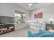 Well-lit bedroom with a cozy daybed, ceiling fan, and large window offering an outdoor view at 29403 N 119Th Ln, Peoria, AZ 85383