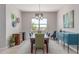 Elegant dining room with a large table, stylish chairs, ample natural light, and contemporary decor creating an inviting space at 29403 N 119Th Ln, Peoria, AZ 85383