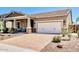 Beautiful single-story home featuring neutral tones, a brick driveway, and a two-car garage at 29403 N 119Th Ln, Peoria, AZ 85383