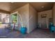 Cozy front porch with rocking chairs, textured walls, and a stylish front door, creating a welcoming entrance at 29403 N 119Th Ln, Peoria, AZ 85383