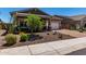 Charming single-story home with desert landscaping, a paved driveway, and a two-car garage at 29403 N 119Th Ln, Peoria, AZ 85383