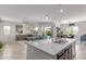Open kitchen concept with an island, stylish pendant lights, stainless steel appliances, and a seamless view into the living area at 29403 N 119Th Ln, Peoria, AZ 85383